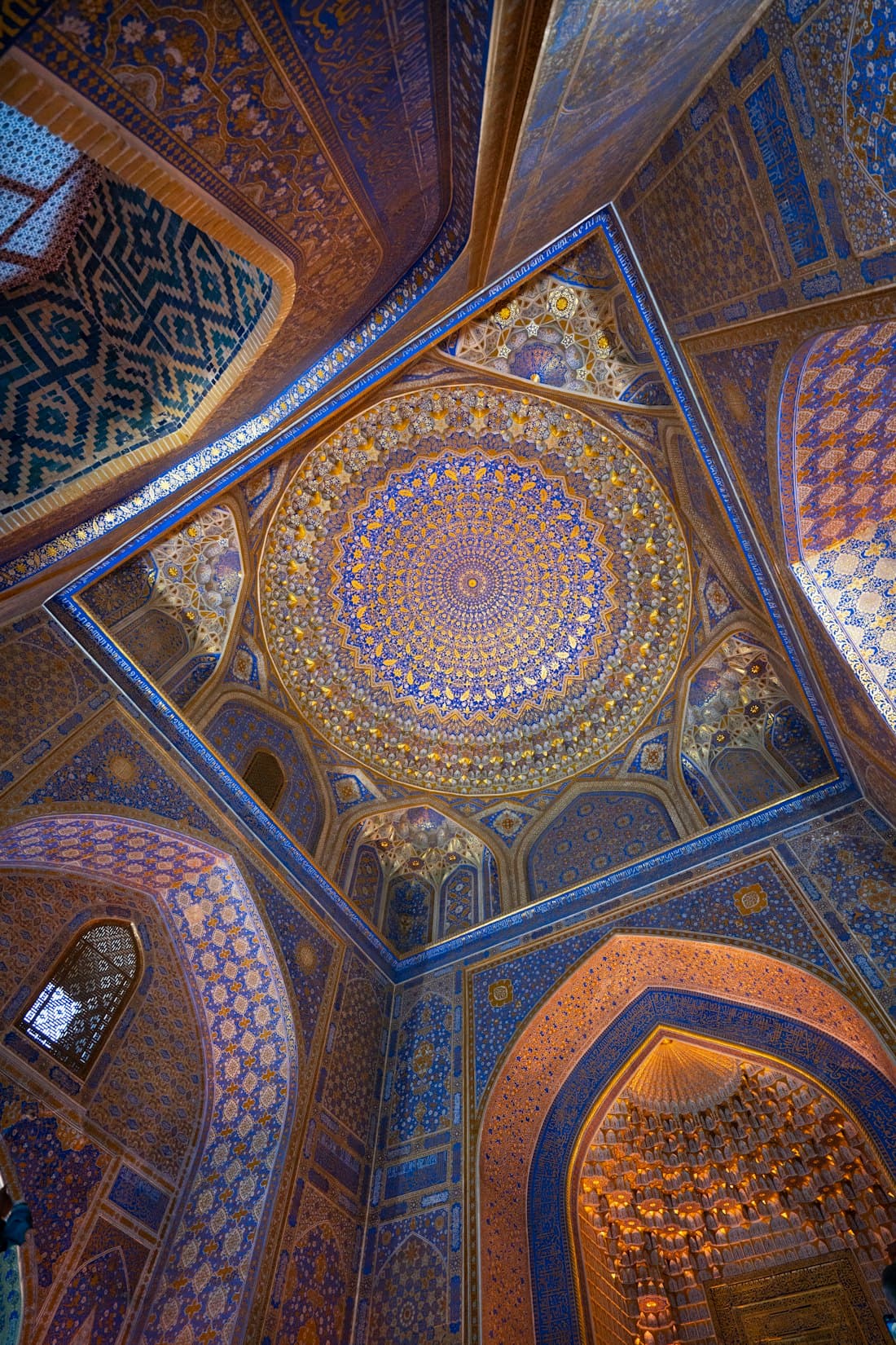 An intricately tiled mosque dome ceiling